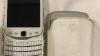 White flipped BlackBerry Torch 9810 with original leather case